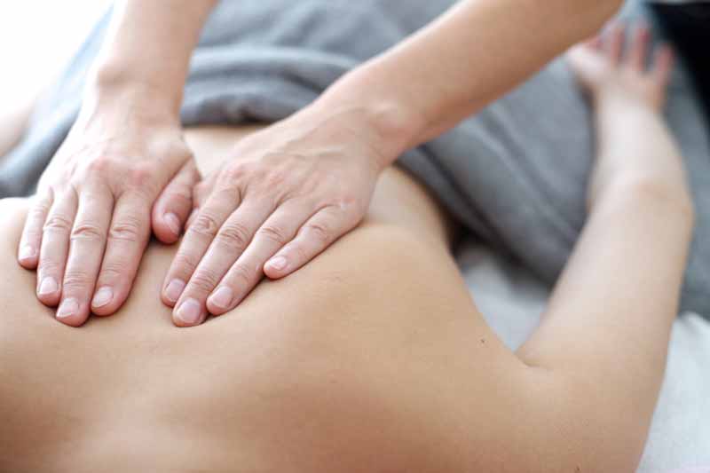 A patient receives manual therapy treatment