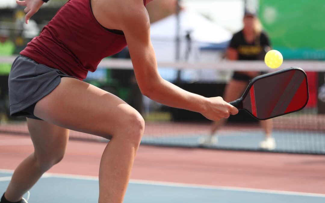 A pickleball player volleying